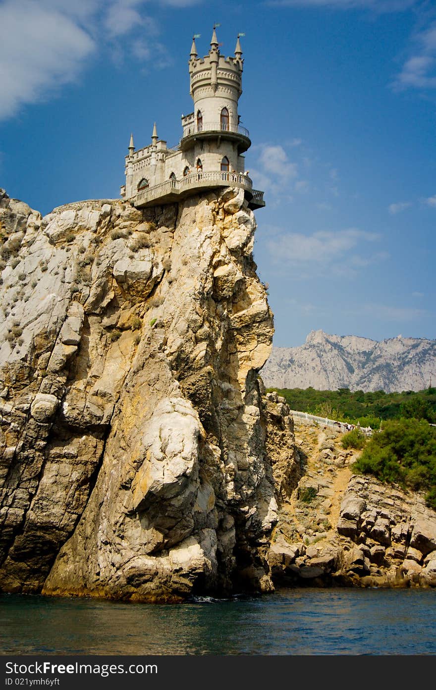 A fortress stands on a rock above a sea. A fortress stands on a rock above a sea