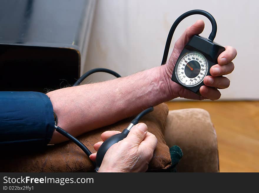 The human taking his blood pressure by himself