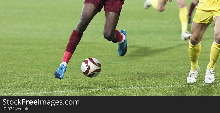 Soccer players running after the ball