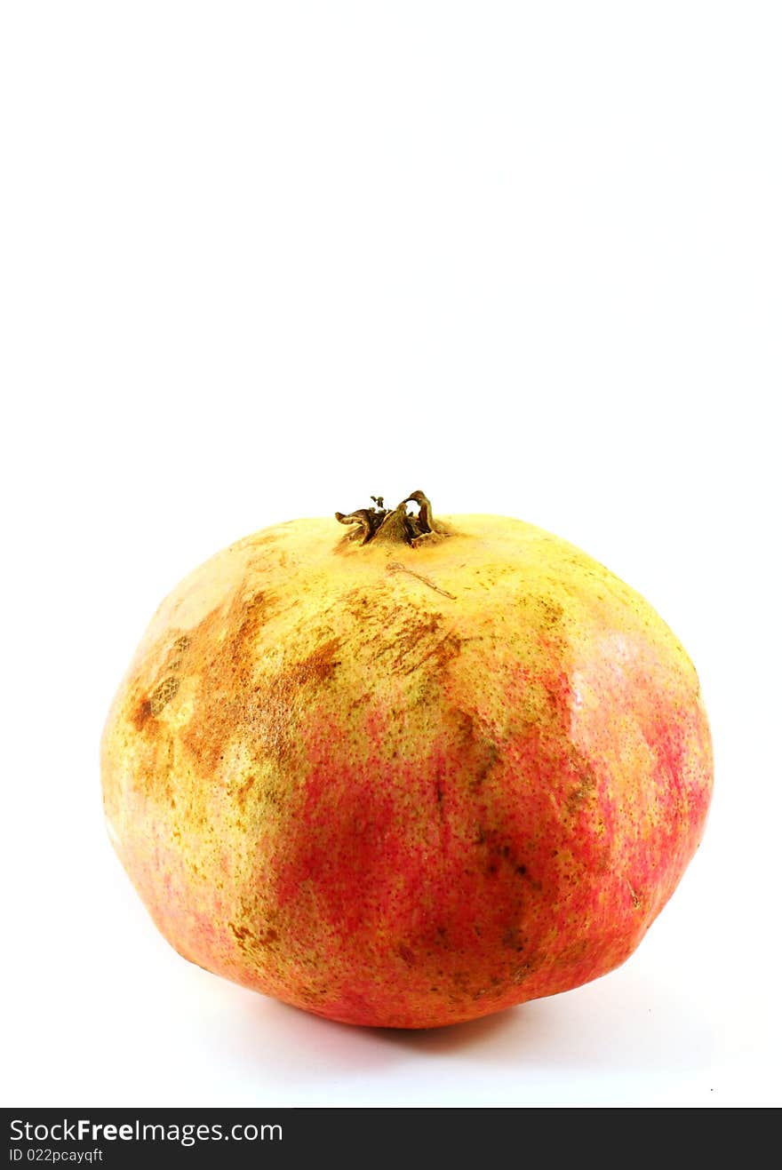 A pretty red juicy pomegranate isolated on white background. A pretty red juicy pomegranate isolated on white background