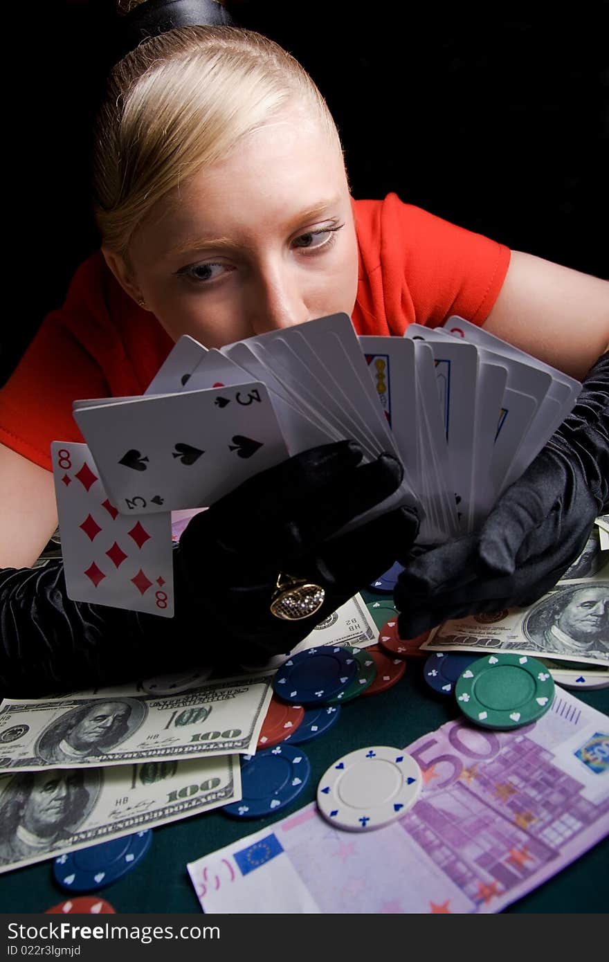 Blond girl holding bunch of playing cards. Blond girl holding bunch of playing cards