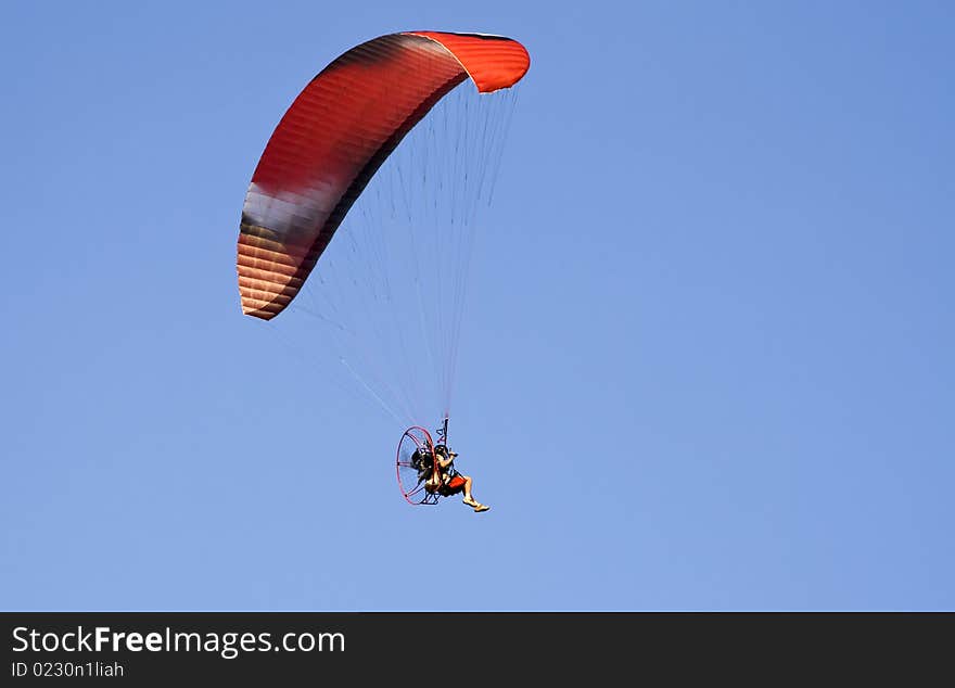 Colorful paraglide on blue sky