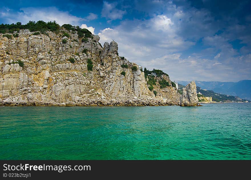 Rocky sea-shore, dark blue sky. Rocky sea-shore, dark blue sky