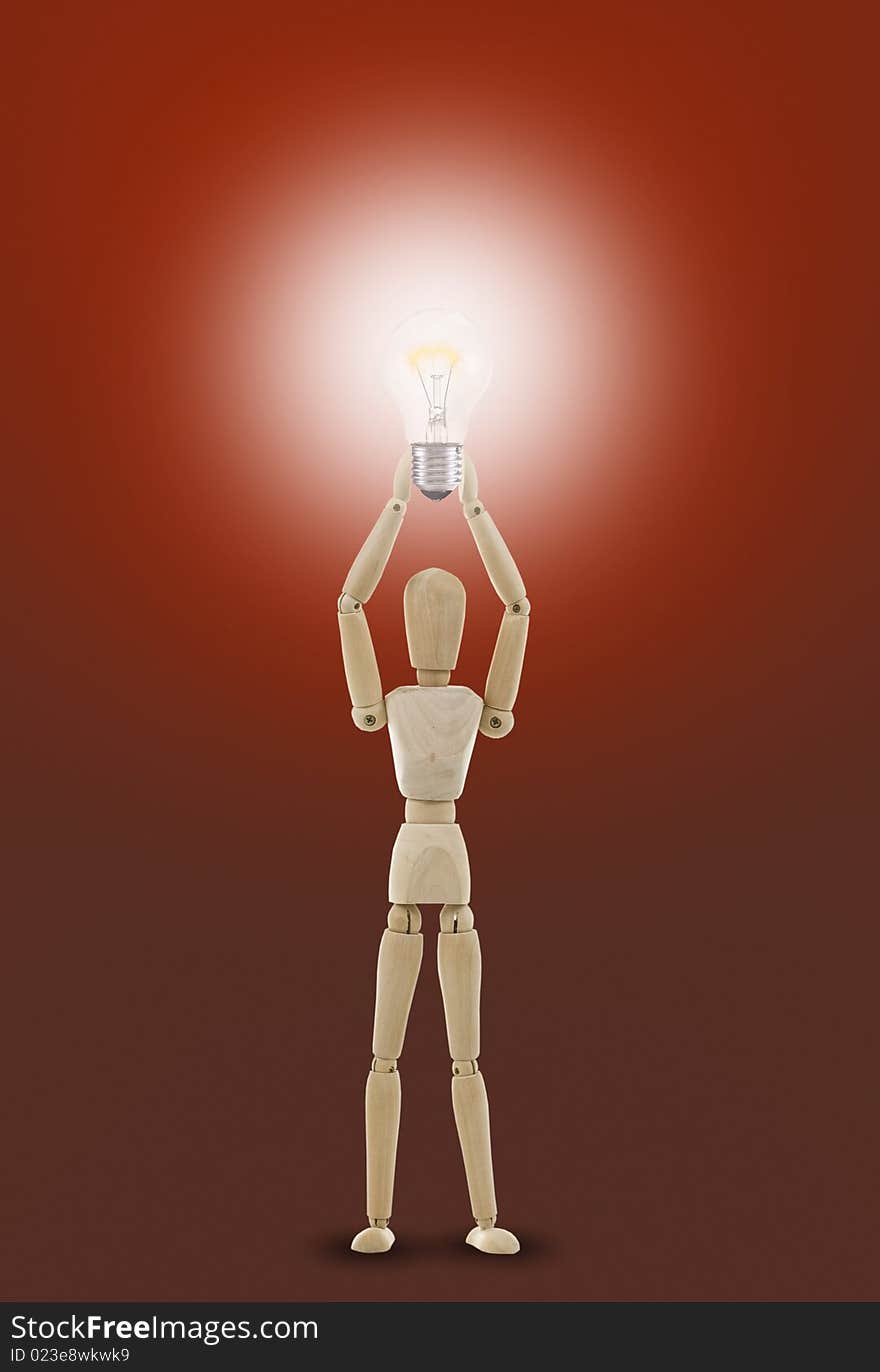 Wooden mannequin holds light bulb, Concept bright idea, solution