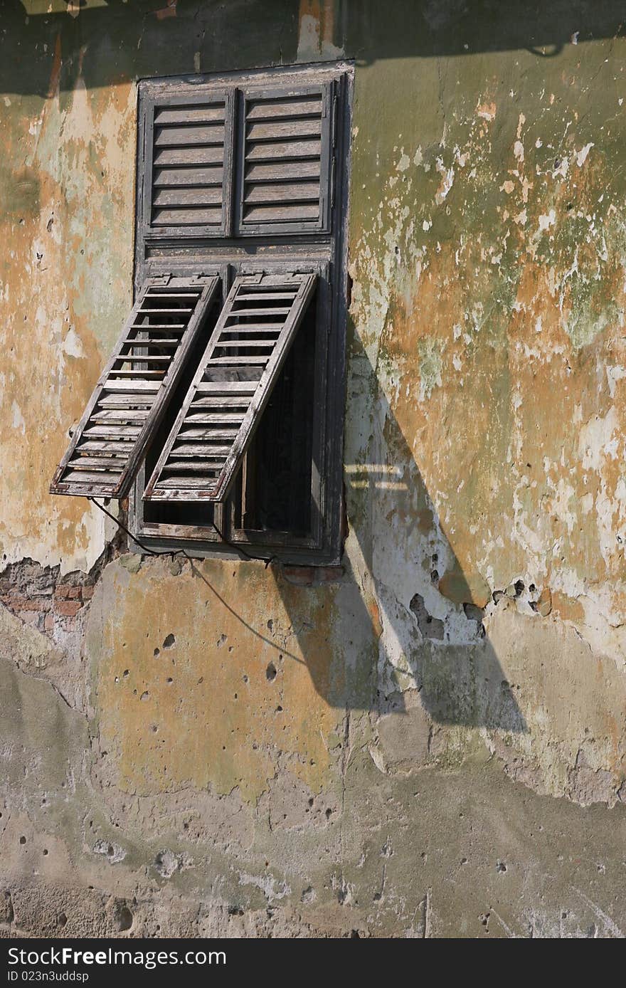 This is an old house with a beautiful window. This is an old house with a beautiful window