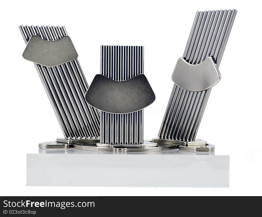 The chromeplated polished metal sticks are fastened together by super magnets from hard disks. The design is similar to a monument. Isolated on white. The chromeplated polished metal sticks are fastened together by super magnets from hard disks. The design is similar to a monument. Isolated on white.