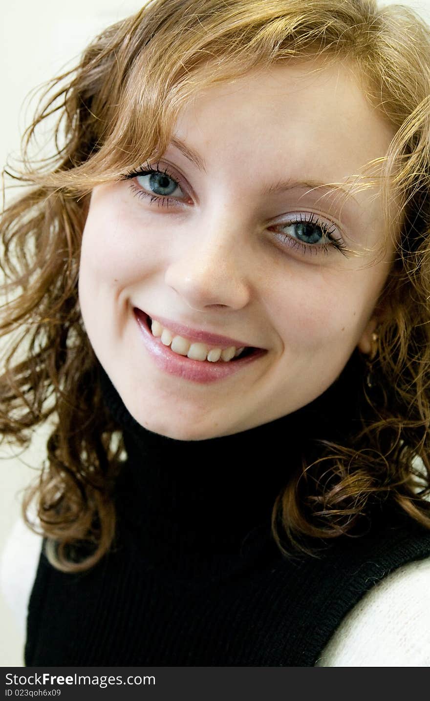 Portrait of young girl with a smile on face and by ringleted hairs. Portrait of young girl with a smile on face and by ringleted hairs