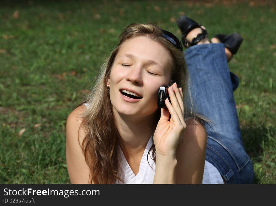 Girl talks on mobile telephone