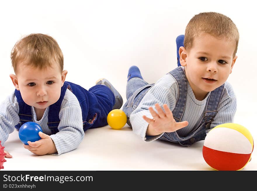 Two adorable boys enjoy with colorful balls. Two adorable boys enjoy with colorful balls