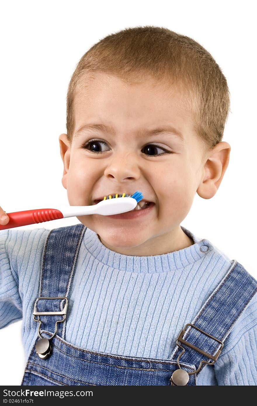 Young boy brushing his teeth with toothbrush, isolated in white