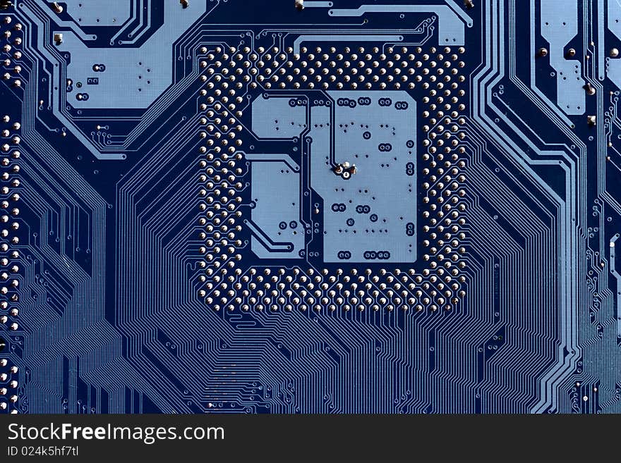 A macro view of the connections and chip slot, on an electronic circuit board. A macro view of the connections and chip slot, on an electronic circuit board.