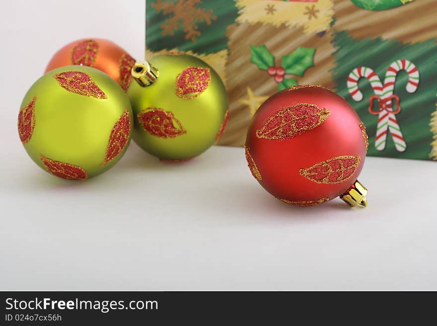 Colorful christmas balls and part of christmas packet lie on the table. Colorful christmas balls and part of christmas packet lie on the table.