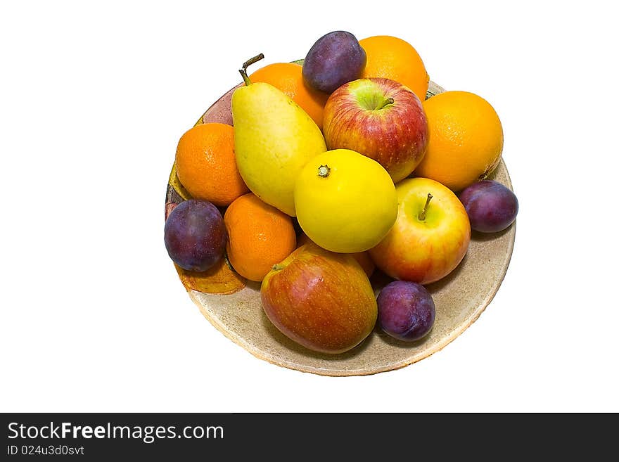 A full dish of colored fruits over white background . A full dish of colored fruits over white background