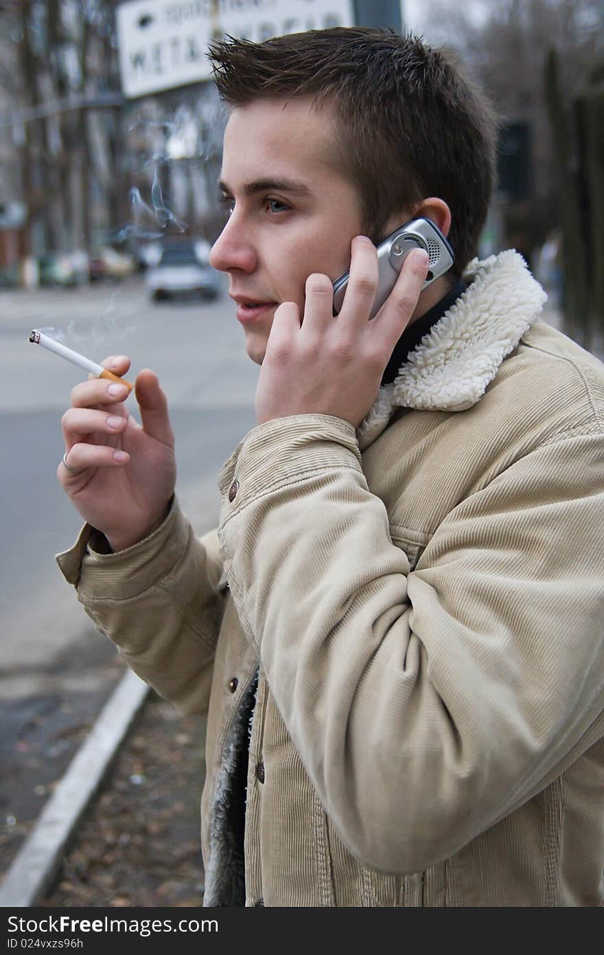 Young smoker on the phone