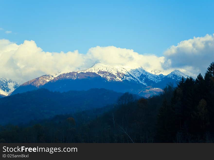 An imagine of the italian Alpes with some clouds on their top,covered with the first snow of the season. An imagine of the italian Alpes with some clouds on their top,covered with the first snow of the season