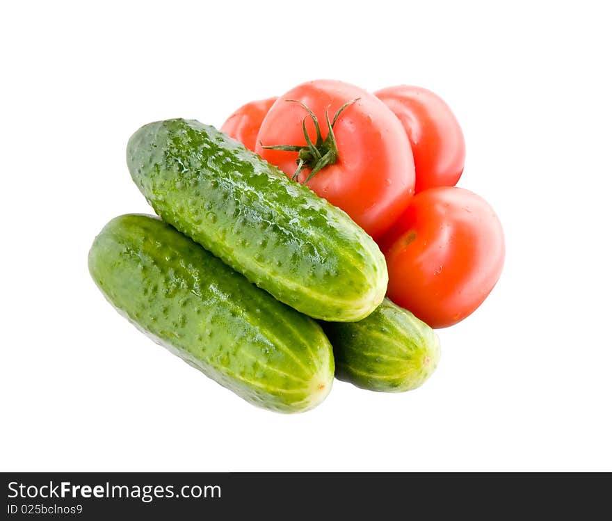 Fresh wet tomatoes and cucumbesr isolated on white. Fresh wet tomatoes and cucumbesr isolated on white