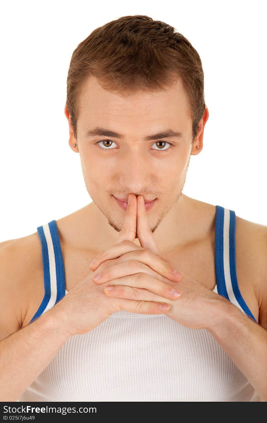 Handsome young man in T-shirt is looking to you, his hands touch lips . Isolated on white background. Handsome young man in T-shirt is looking to you, his hands touch lips . Isolated on white background