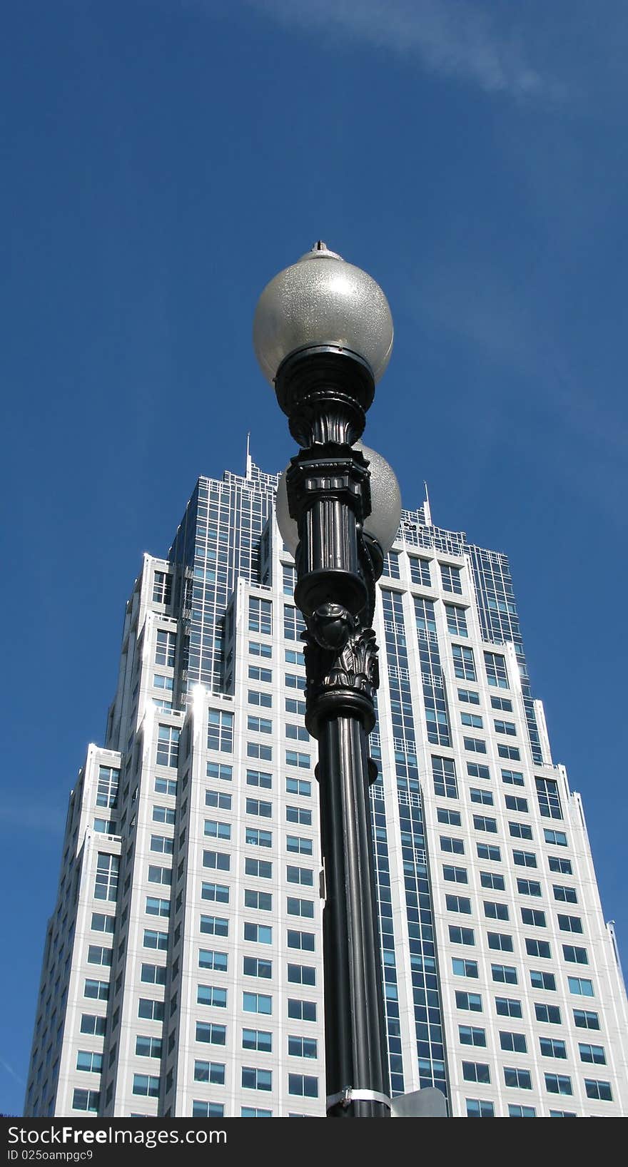 Tall building in the city of Boston with a streetlamp in the foreground. Tall building in the city of Boston with a streetlamp in the foreground.