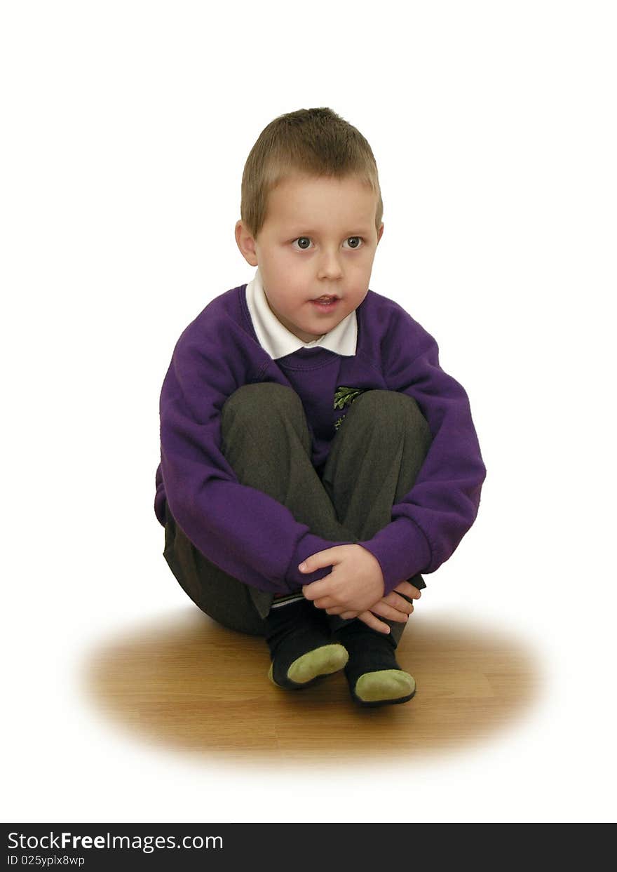 A little school-boy sitting with his hands around his knees, concentrated, focused, listening, looking forward; isolated on white background. *** If you need more variations on this theme, feel free to contact me (leave a comment via Tools tab). ***. A little school-boy sitting with his hands around his knees, concentrated, focused, listening, looking forward; isolated on white background. *** If you need more variations on this theme, feel free to contact me (leave a comment via Tools tab). ***