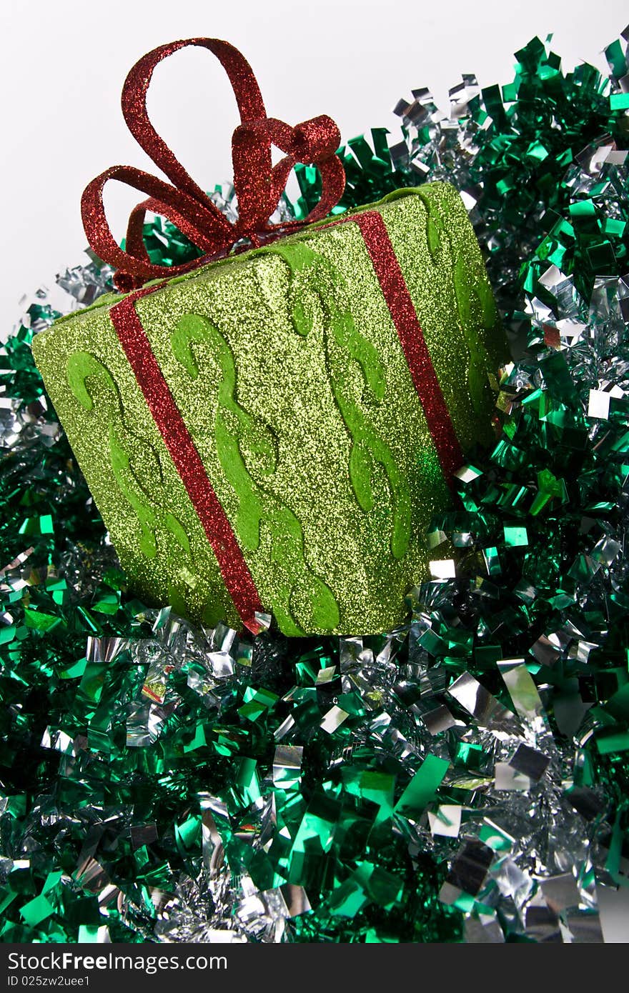 Green sparkling gift box for Christmas and spangle on white background. Green sparkling gift box for Christmas and spangle on white background