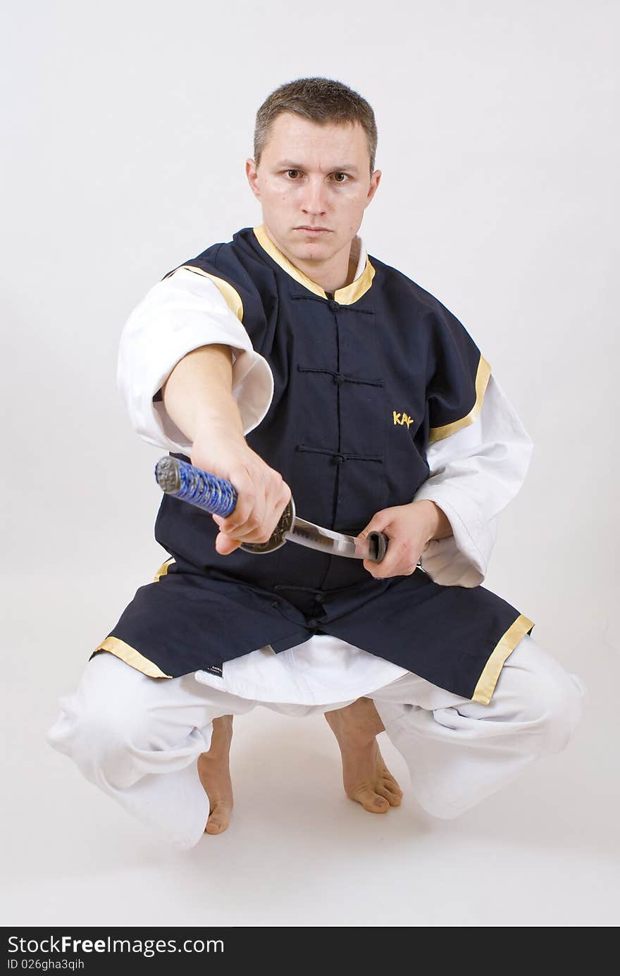 Karate men with sword on grey background