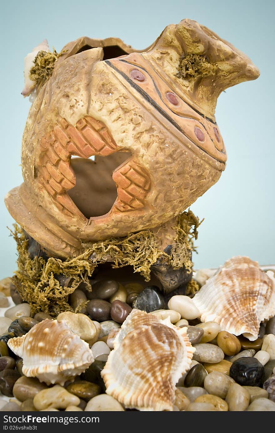 Ancient vase with stones and seashell