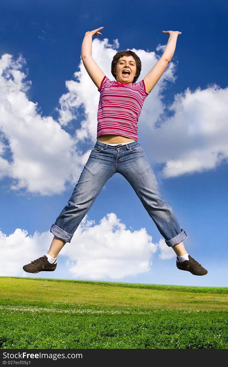 Young Happy Woman Jumping High Against Blue Sky