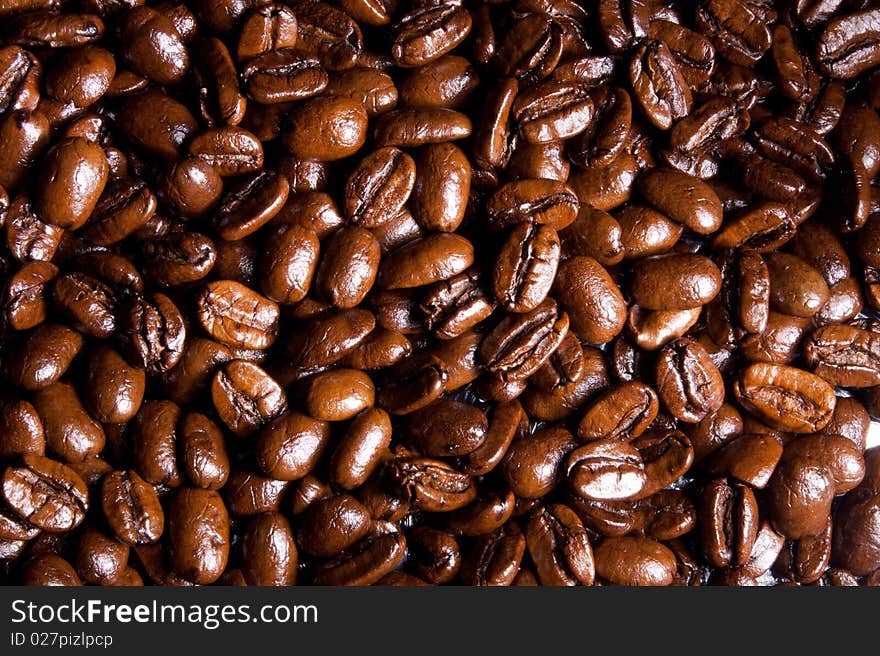 Coffee beans background in dark brown colors