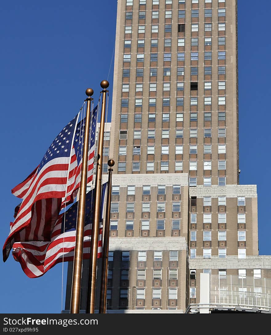 Exterior of modern skyscraper building with American flags in foreground, New York City, U.S.A. Exterior of modern skyscraper building with American flags in foreground, New York City, U.S.A.