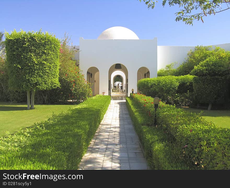 Beautiful garden at hotel resort and building in traditional arabic style. Beautiful garden at hotel resort and building in traditional arabic style