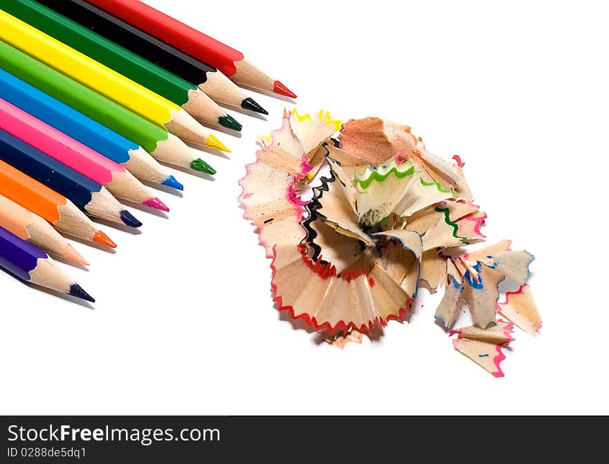 Sharpened colored pencils with the chips on a white background. Sharpened colored pencils with the chips on a white background