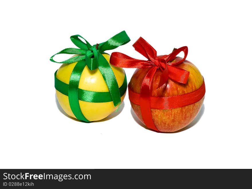 Couple of red and yellow apples with a gift bows on a white background