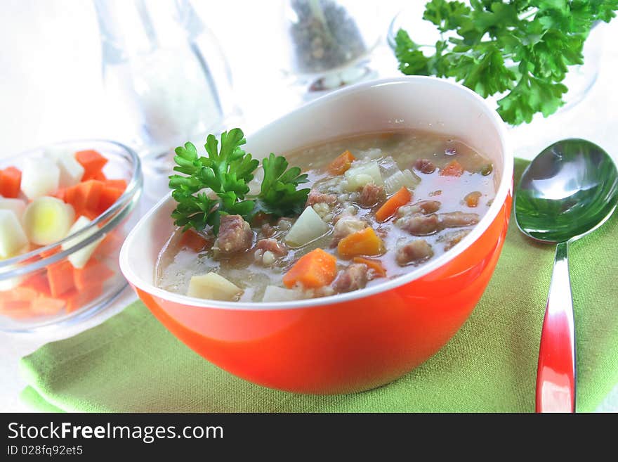 A bowl of soup with a green napkins. A bowl of soup with a green napkins