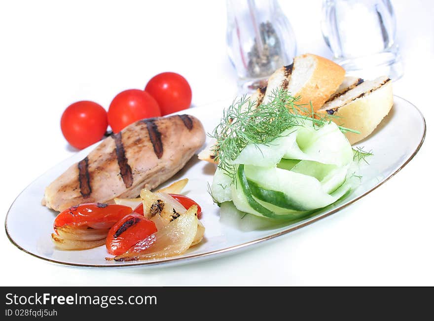 Chicken breast with grilled vegetables and cucumber salad. Chicken breast with grilled vegetables and cucumber salad