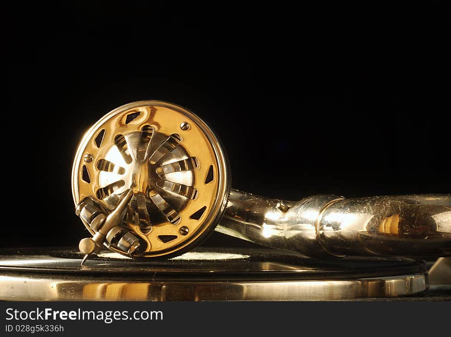 Old gramophone playing against black background. Old gramophone playing against black background