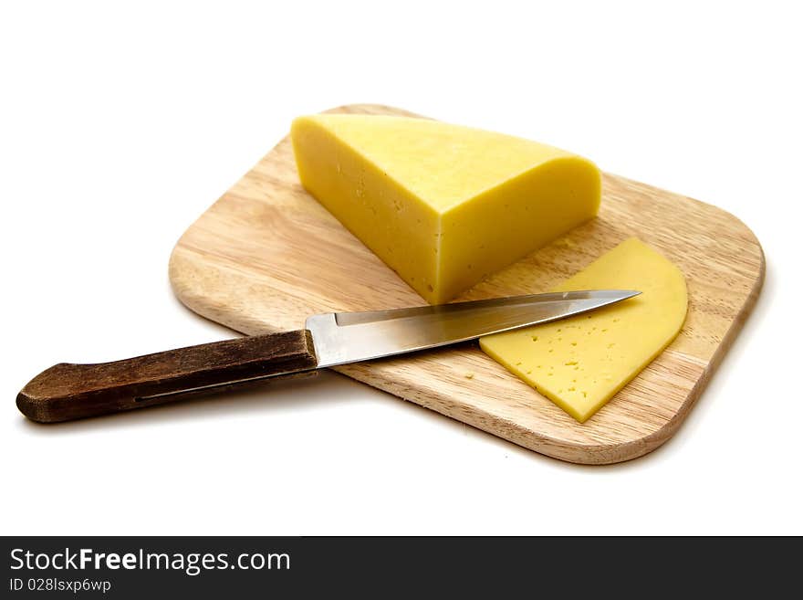 Block of cheese on cutting board with a knife, isolated on white background. Block of cheese on cutting board with a knife, isolated on white background