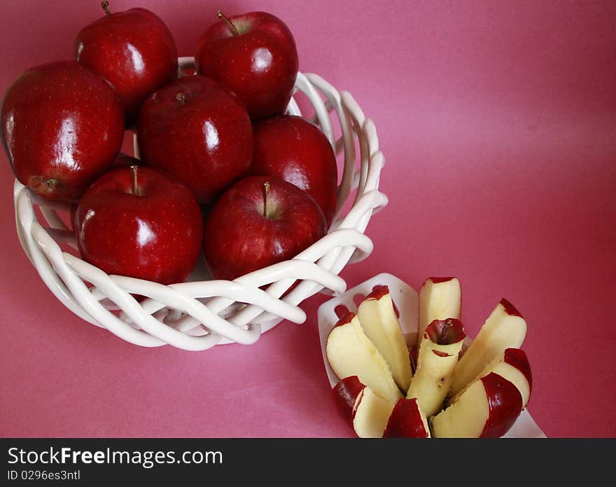 Apples sitting inside a fruit basket with an apple cutter with an apple cut up inside landscape. Apples sitting inside a fruit basket with an apple cutter with an apple cut up inside landscape