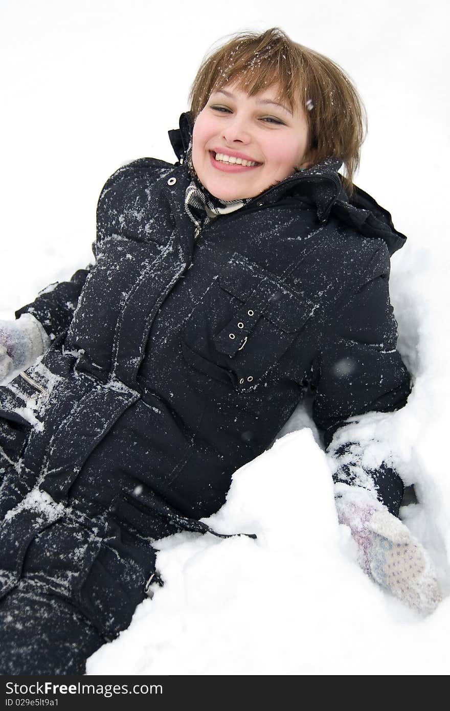 Smiling girl laying in snow