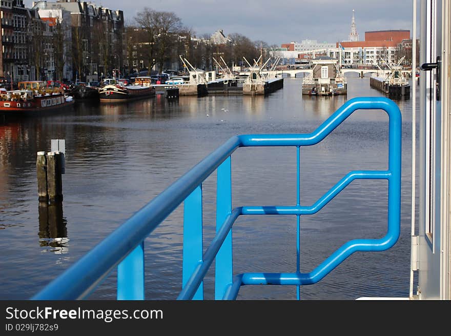 A door with canal houses on the background, famous in Amsterdam. A door with canal houses on the background, famous in Amsterdam