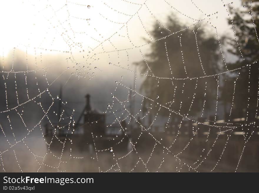 Leonardo's ferry on Adda's river between the threads of a spider's web and the morning fog. Leonardo's ferry on Adda's river between the threads of a spider's web and the morning fog