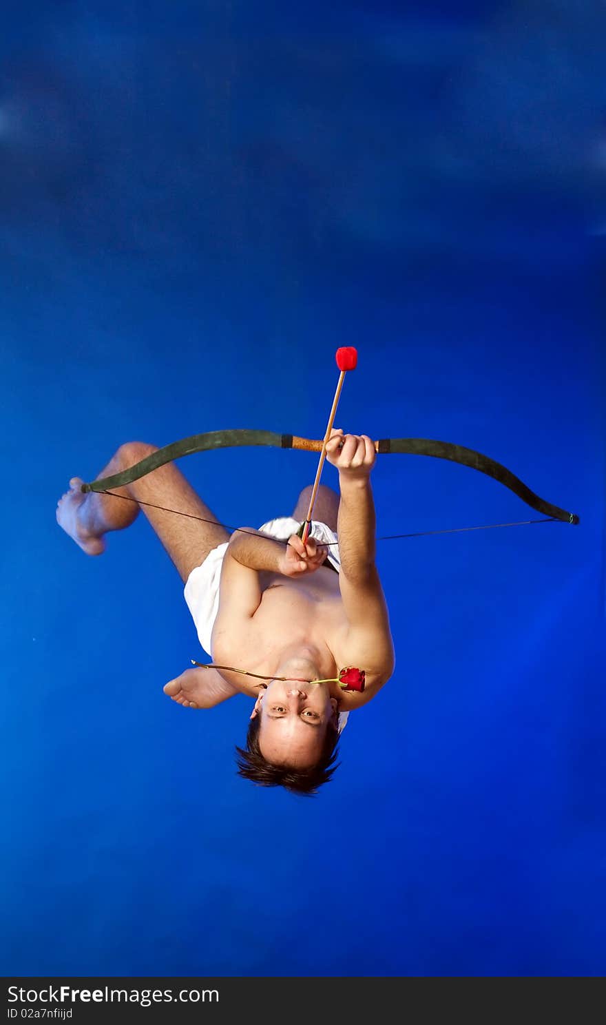 Cupid with bow flying on blue background. Cupid with bow flying on blue background