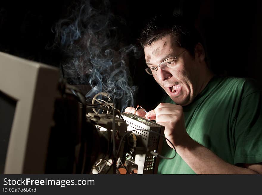 Man Repairing Computer On Fire