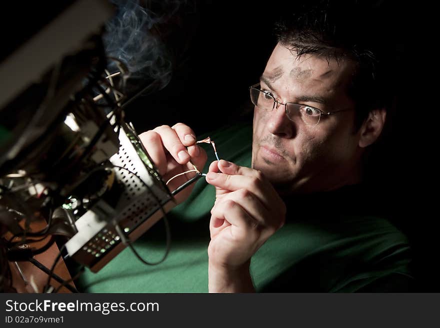 Man Repairing Computer On Fire