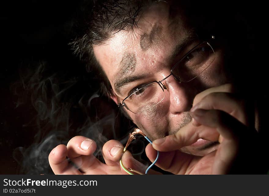 Man repairing old computer on fire