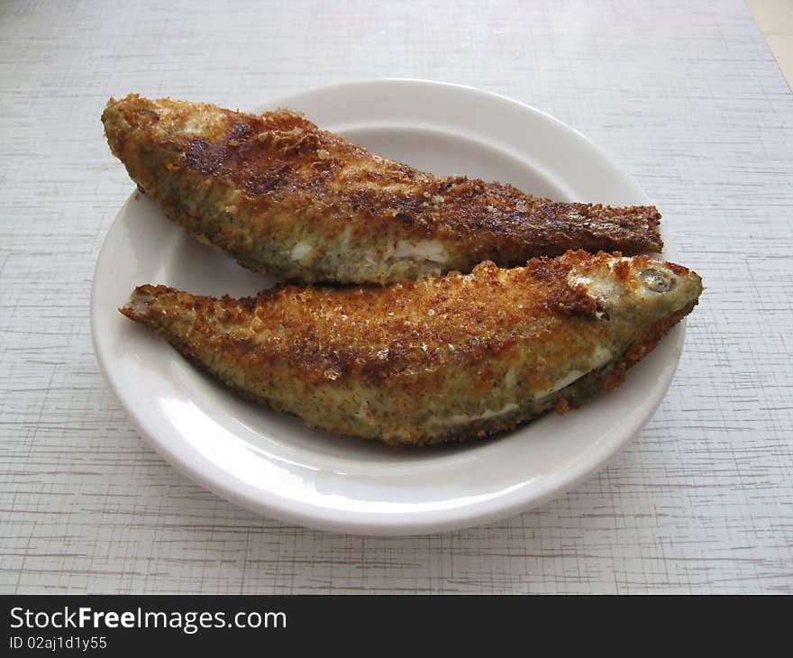 This is fired fish on white plate