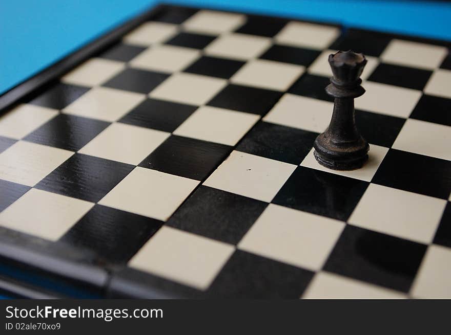 An old dusty chess board with a tower on it