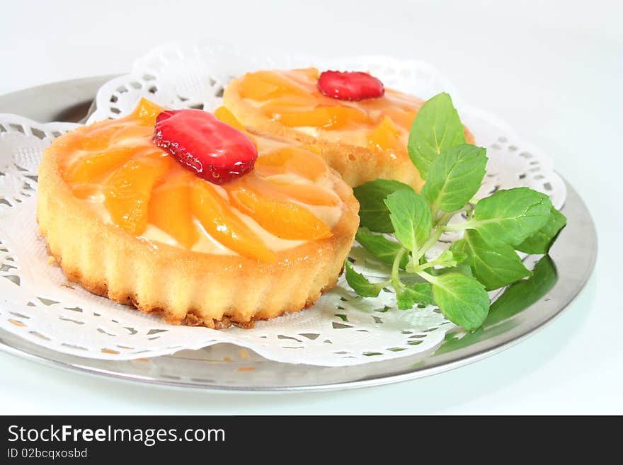 Apricot tart with lemon balm on a silver platter