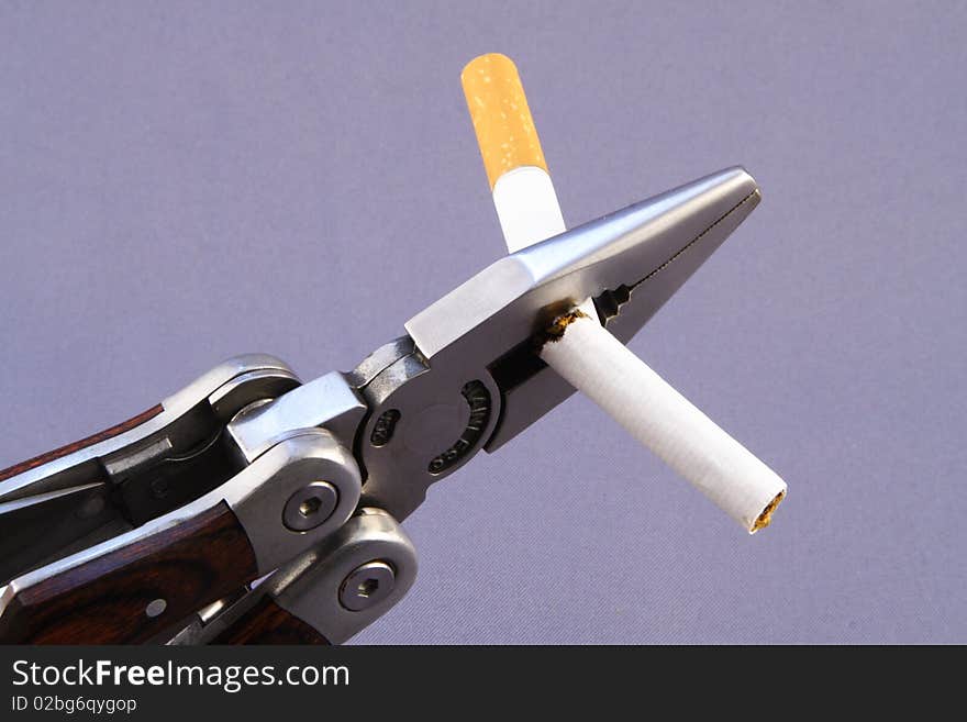 Close up of a claw cutting a cigarette in half. Close up of a claw cutting a cigarette in half