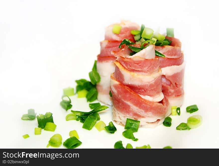 Bacon with green onion on a white background