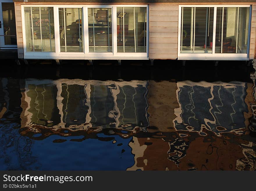 A floating boat in Amsterdam reflecting in the water. A floating boat in Amsterdam reflecting in the water